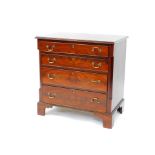 An Edwardian mahogany chest of four long graduated drawers, raised on bracket feet, 80cm high, 77.