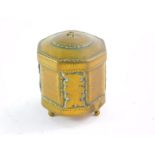 A Tibetan Buddhist brass and horn prayer wheel, of octagonal form, raised on three brass feet, 6.5cm