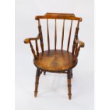 An early 19thC beech penny seated elbow chair, bears traces of label, raised on turned legs united