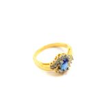 A Royal Tru sapphire and cubic zirconia ring, set in yellow metal, in a crossover design, size M,