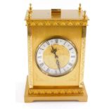 A Junghans brass cased carriage clock, the circular dial with silvered chapter ring bearing Roman