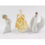 A Lladro porcelain figure modelled as a swan, 20cm wide., a cherub playing a musical instrument,