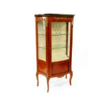 A Louis XV style mahogany and kingwood bow fronted vitrine, with a marble top, glazed sides and door
