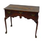 A Georgian mid 18thC oak and elm lowboy, with one long and two short deep drawers above a shaped