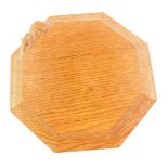 A Robert Thompson Mouseman oak octagonal cheese board, carved with a mouse to the edge, 19cm