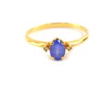 A pale light amethyst and diamond three stone ring, set in yellow metal, stamped 18k, size V, 1.7g.