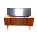 A G Plan teak dressing table, the oblong mirror over three long drawers, flanked by a pair of