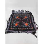 A Chinese vintage black silk shawl, probably early 20thC embroided with flowers, with a black