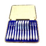 An Edward VII silver handled fruit set, comprising six forks and knives, cased, Sheffield 1904, 9.