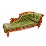 A Victorian mahogany chaise longue, upholstered in buttoned green leather, raised on turned legs, on