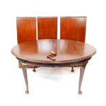 A Victorian mahogany wind out dining table, with three and half additional leaves, raised on