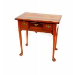 A George III mahogany side table, with three short frieze drawers, raised on turned legs, on pad