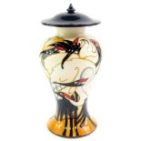 A Moorcroft pottery vase and cover, decorated in The Cranes of Cashmere pattern, of baluster form by