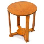 An Art Deco oak circular occasional table, raised on square supports united by an X frame base