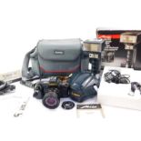 A Canon T70 camera, with a 35/70mm zoom lens, a Canon slide duplicator, no. 55, boxed and a Metz