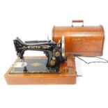 A Singer oak cased electric sewing machine.