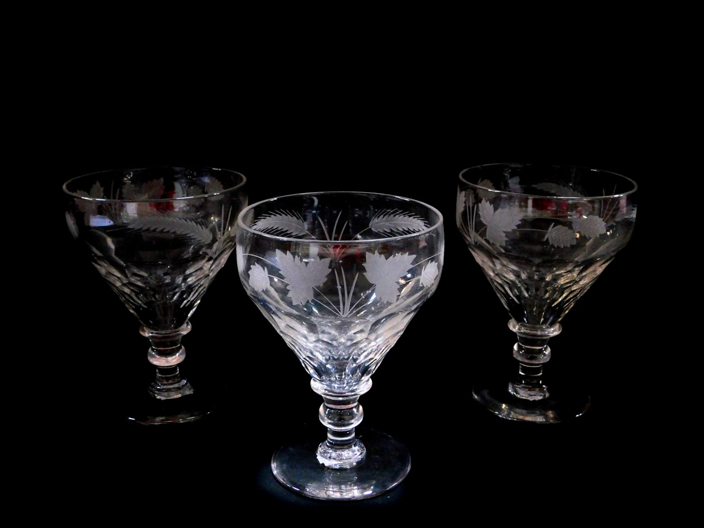 A set of three Victorian cut glass rummers, the faceted bowls engraved above with hops, raised on