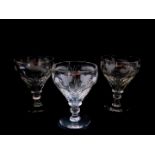 A set of three Victorian cut glass rummers, the faceted bowls engraved above with hops, raised on