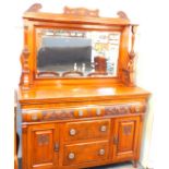 A Victorian walnut mirror back sideboard, with an Art Nouveau fall, carved pediment, above a shelf