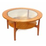 A Nathan Shades teak circular occasional table, with glass inset, based on square supports, raised
