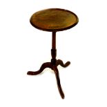A George III mahogany wine table, the circular top raised on a turned column over three cabriole