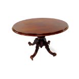 A Victorian mahogany tilt top breakfast table, with an oval top, raised on a turned column over four