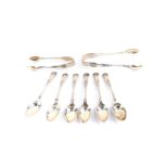 A pair of Edward VII silver sugar tongs and six coffee spoons, decorated in the King's pattern,
