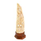 An Indian ivory carving of Shiva, modelled standing on a lotus flower, with flowering around her,