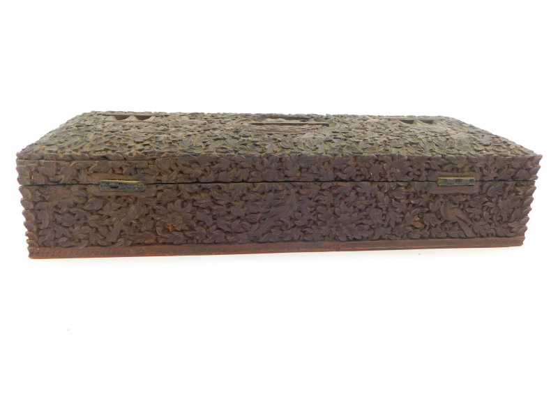 An Anglo Indian 19thC hardwood box, of rectangular form, carved with a recumbent deity, temples, - Image 5 of 7