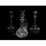 A pair of cut glass globe and shaft decanters and stoppers, a mallet shaped cut glass decanter and