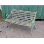 A Victorian style garden bench, with cast iron supports and slatted seat.