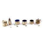 A silver three piece condiment set, with blue glass liners and mustard spoon, Birmingham 1960, an