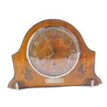 An Art Deco walnut and inlaid mantel clock, dial bearing Arabic numerals, eight day movement with