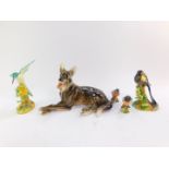 A Keramos porcelain figure of German shepherd dog, in recumbent pose, 29cm wide, two Crown