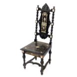 An Italian late 19thC ebonised and ivory inlaid hall chair, possibly Milanese, with a foliate carved