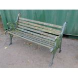 A Victorian style garden bench, with cast iron supports and slatted seat.