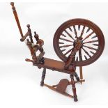 A turned mahogany spinning wheel, 90cm to wheel height, 54cm diameter.