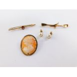A 9ct gold opal and seed pearl bar brooch, 1.2g, a gold plated pennant and skulls bar brooch, a