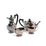 A silver four piece tea set, of fluted footed form, Sheffield 1962/64, comprising teapot, hot