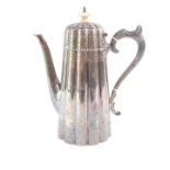 A Victorian silver coffee pot, of fluted outset form, engraved with bands of repeating flower heads,