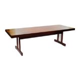 A Scandinavian late 20thC dining table, with a figured rectangular top, raised on double square
