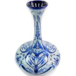 A Moorcroft pottery 2003 vase, tube line decorated in the Florian style with blue on blue flowers,