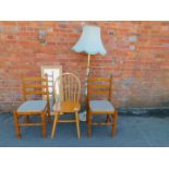 A pair of pine dining chairs, a stick back chair, an oak laminate mirror, together with an onyx