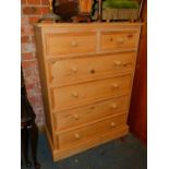 A pine chest of drawers, two over four drawers, raised on a plinth base, 116cm high, 85cm wide, 41cm