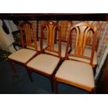 A set of six late 20thC teak dining chairs, upholstered in a cream diamond fabric.