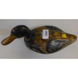 A painted wooden decoy duck, 27.5cm wide.