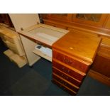 A Singer Concerto 9 electric sewing machine, enclosed within a teak cabinet, 78cm high, 98cm wide,