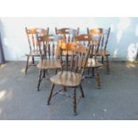 A set of six stained beech dining chairs, with turned spindles and legs.