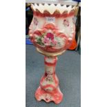 A pottery jardiniere on stand, printed with reserves of roses, gilt heightened, 76cm high.