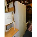 A cream painted two door wardrobe, 193cm high, 80cm wide, 54cm deep.